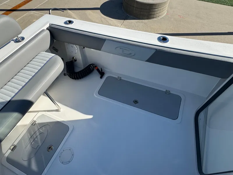 Slide: The Image of Interior view of 2025 Defiance San Juan 220 boat, featuring seating and storage compartments. - 22
