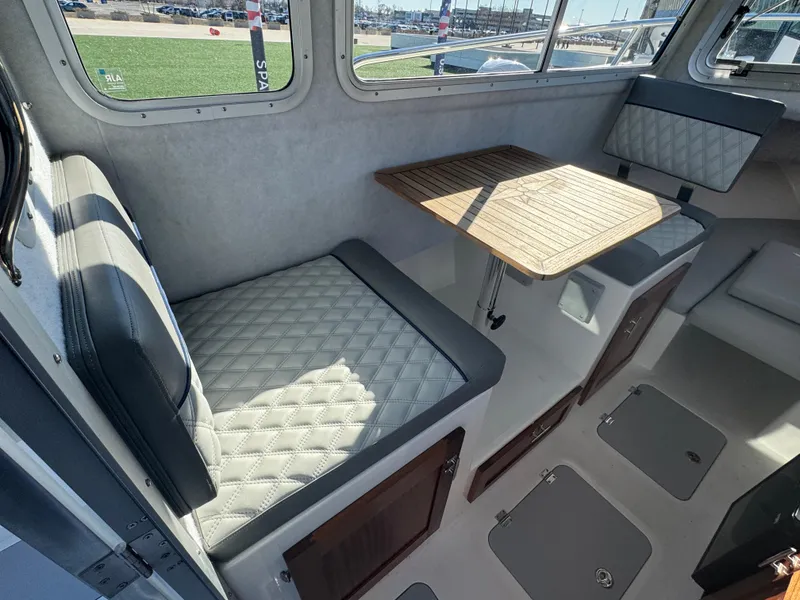 Slide: The Image of Interior of 2025 Defiance San Juan 220 boat with seating and table. - 25