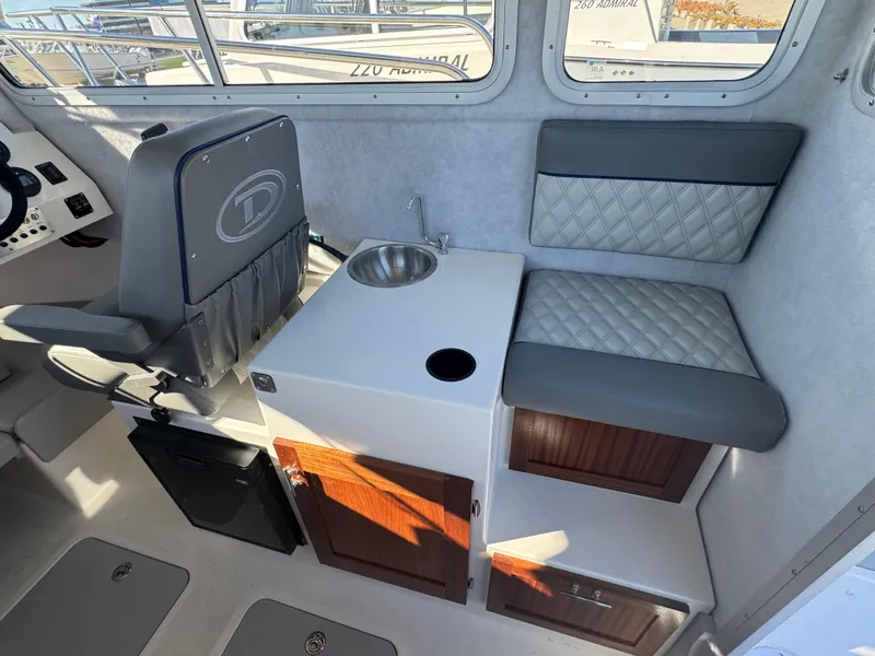 Slide: The Image of Interior of 2025 Defiance San Juan 220 boat with seating and sink. - 26