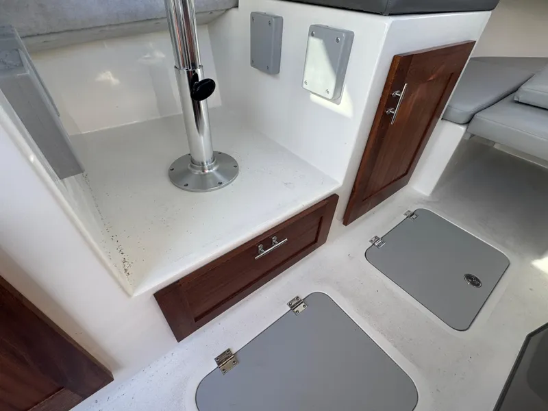 Slide: The Image of Interior of 2025 Defiance San Juan 220 boat, featuring storage compartments and seating area. - 27