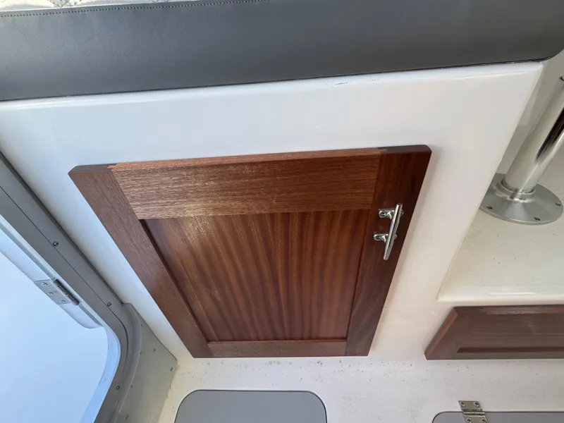 Slide: The Image of Wooden cabinet door inside 2025 Defiance San Juan 220 boat interior. - 28