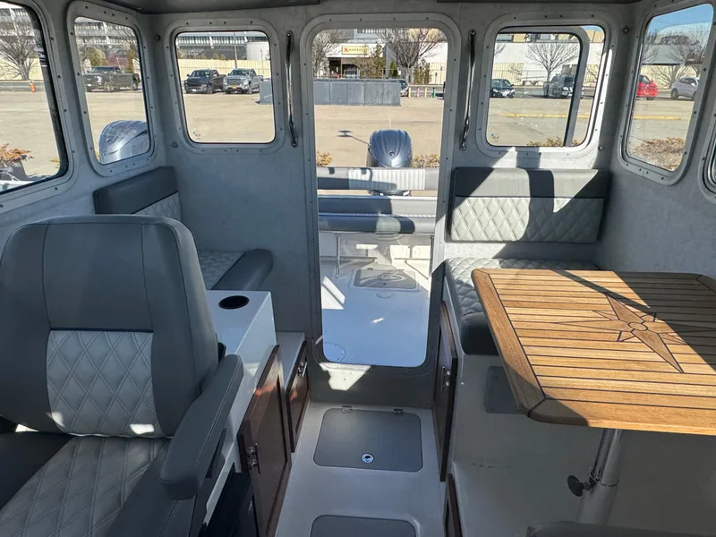 Slide: The Image of Interior of 2025 Defiance San Juan 220 boat with seating and wooden table. - 34