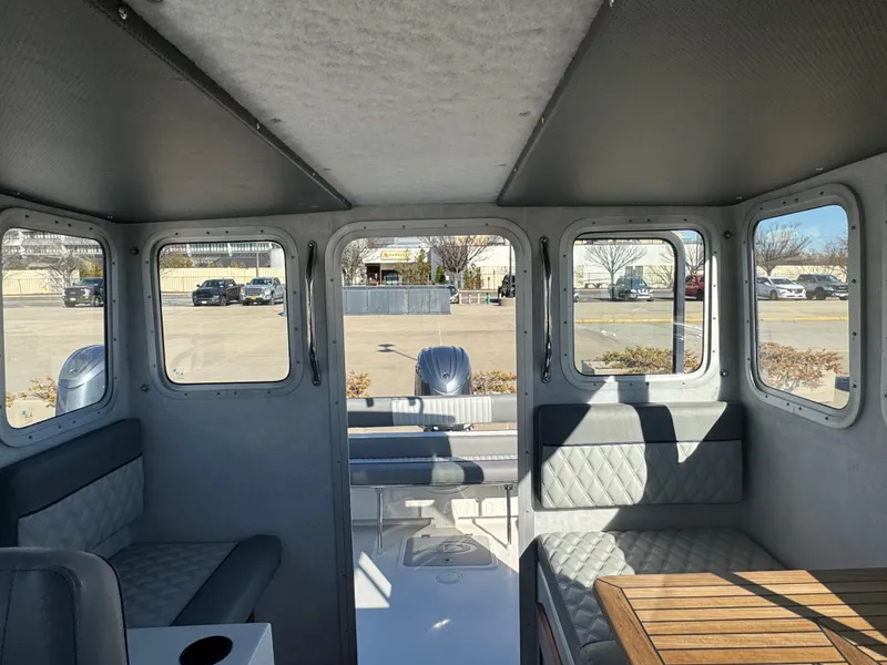 Slide: The Image of Interior of 2025 Defiance San Juan 220 boat with seating and windows. - 35