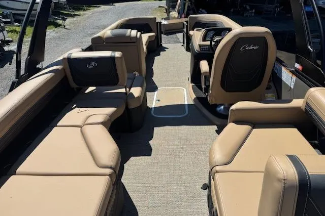Slide: The Image of 2026 Barletta Cabrio 24M pontoon boat interior with beige seating and modern dashboard. - 11