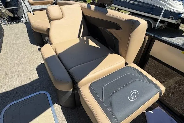 Slide: The Image of Luxurious seating on 2026 Barletta Cabrio 24M pontoon boat, featuring tan and black upholstery. - 12