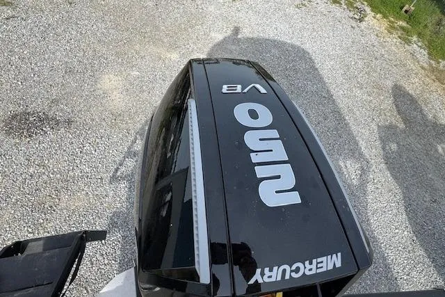 Slide: The Image of Mercury outboard engine on Barletta Cabrio 24M, 2026 model, parked on gravel. - 13