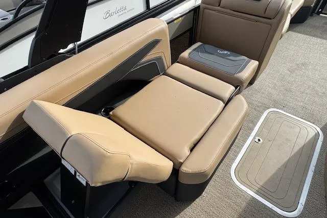 Slide: The Image of 2026 Barletta Cabrio 24M boat interior with tan seating and storage compartment. - 18