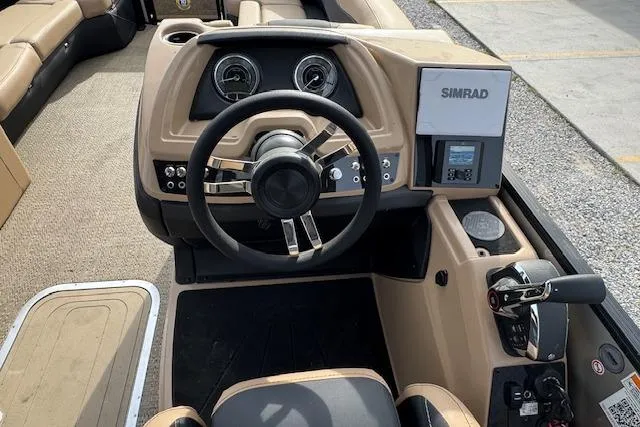 Slide: The Image of 2026 Barletta Cabrio 24M boat dashboard with steering wheel and Simrad navigation system. - 20