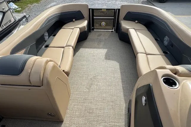 Slide: The Image of 2026 Barletta Cabrio 24M pontoon boat interior with beige seating and carpet flooring. - 21