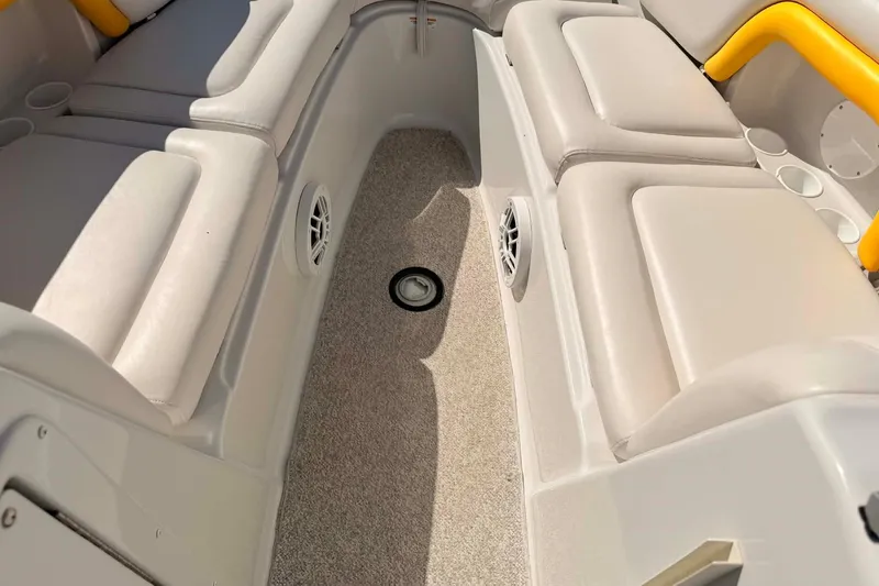 Slide: The Image of Interior of a 2005 Crownline 270 BR boat with beige seating and carpeted floor. - 16