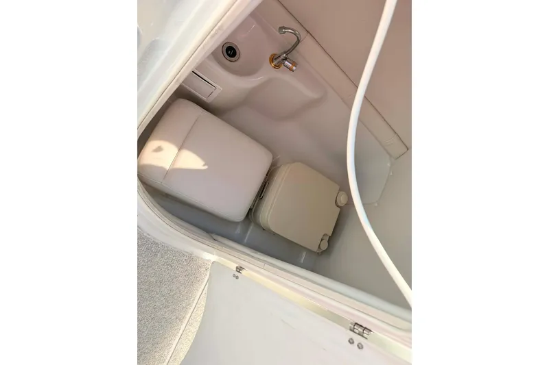 Slide: The Image of Interior of 2005 Crownline 270 BR boat bathroom with sink and toilet. - 4