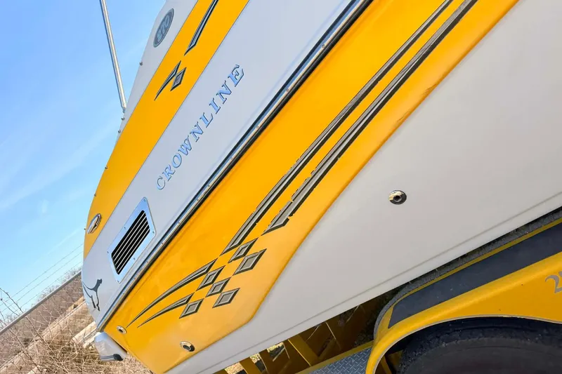 Slide: The Image of Yellow and white 2005 Crownline 270 BR boat with sleek design and graphics. - 9