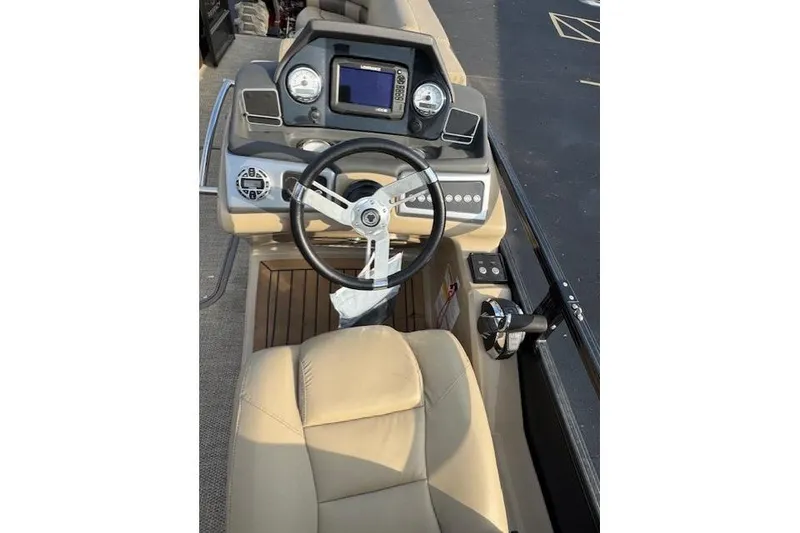 Slide: The Image of 2019 Regency 230 LE3 boat dashboard with steering wheel and control panel. - 13
