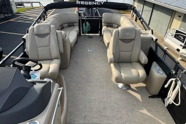 Slide: The Image of 2019 Regency 230 LE3 pontoon boat with beige seating and spacious deck layout. - 14