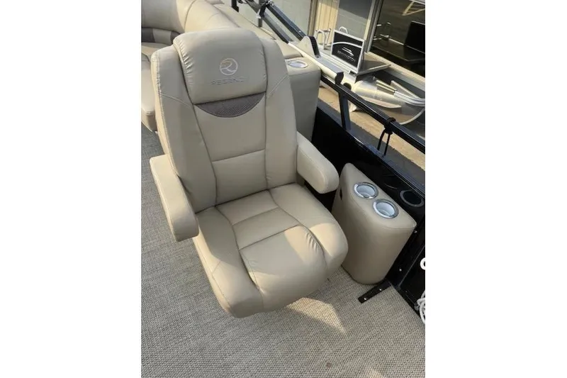 Slide: The Image of Luxurious beige captain's chair on 2019 Regency 230 LE3 boat, featuring cup holders. - 18
