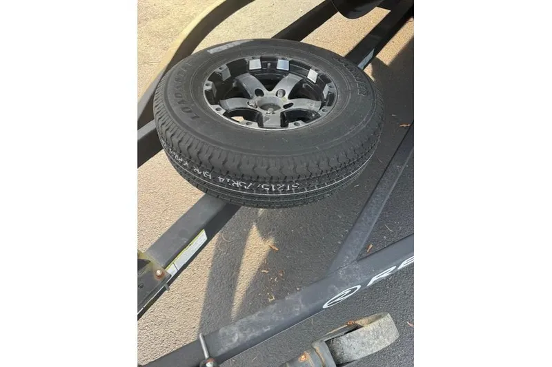 Slide: The Image of Spare tire mounted on a 2019 Regency 230 LE3 trailer frame. - 20