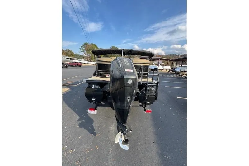 Slide: The Image of 2019 Regency 230 LE3 pontoon boat with outboard motor in parking lot. - 22