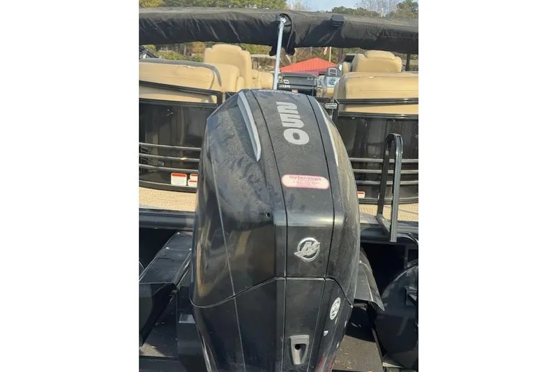 Slide: The Image of 2019 Regency 230 LE3 boat with powerful outboard motor, docked outdoors. - 23