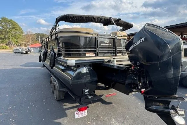 Slide: The Image of 2019 Regency 230 LE3 pontoon boat with Mercury outboard motor on a trailer. - 25