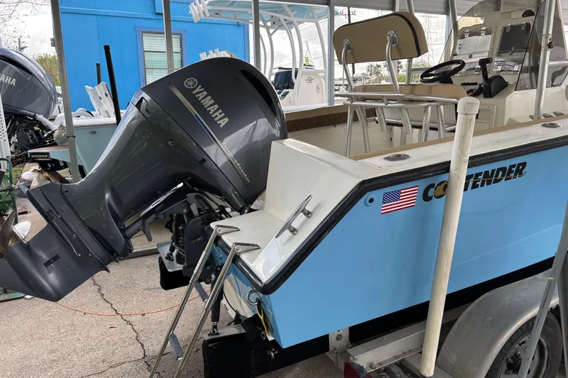 Slide: The Image of 1999 Contender 21 Open boat with Yamaha outboard motor, docked and ready for use. - 11