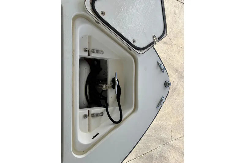 Slide: The Image of Open storage compartment of a 1999 Contender 21 Open boat, showing interior details. - 14