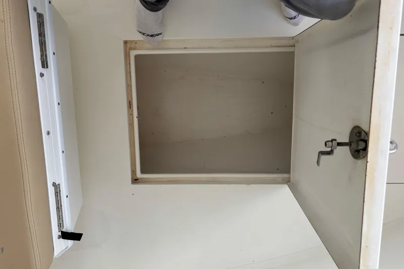 Slide: The Image of Open storage compartment on a 1999 Contender 21 Open boat interior. - 16