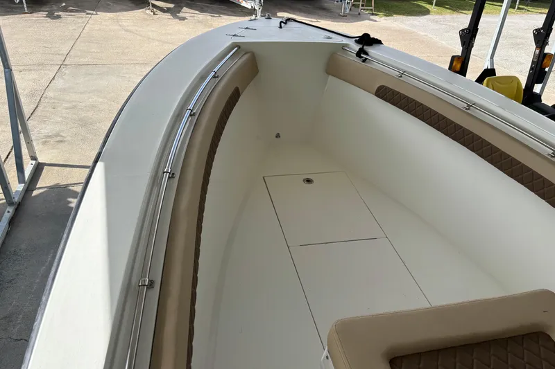 Slide: The Image of 1999 Contender 21 Open boat interior with beige seating and stainless steel railings. - 17