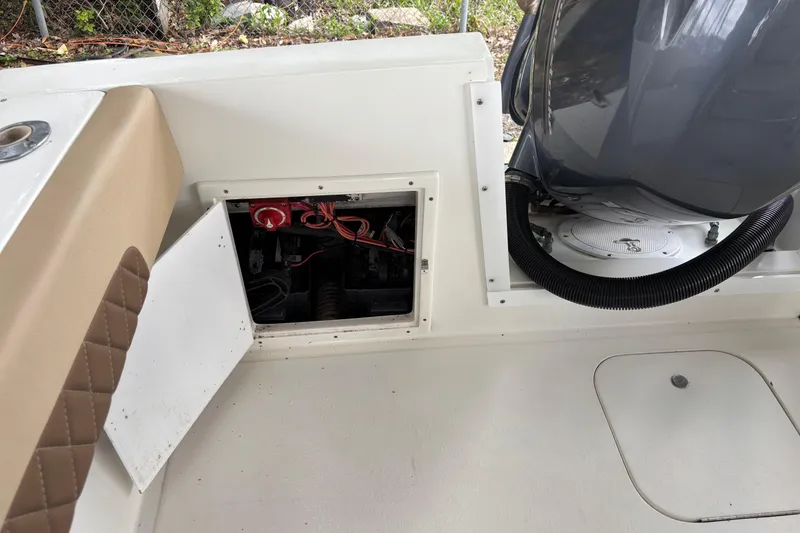 Slide: The Image of 1999 Contender 21 Open boat showing open battery compartment and engine area. - 20