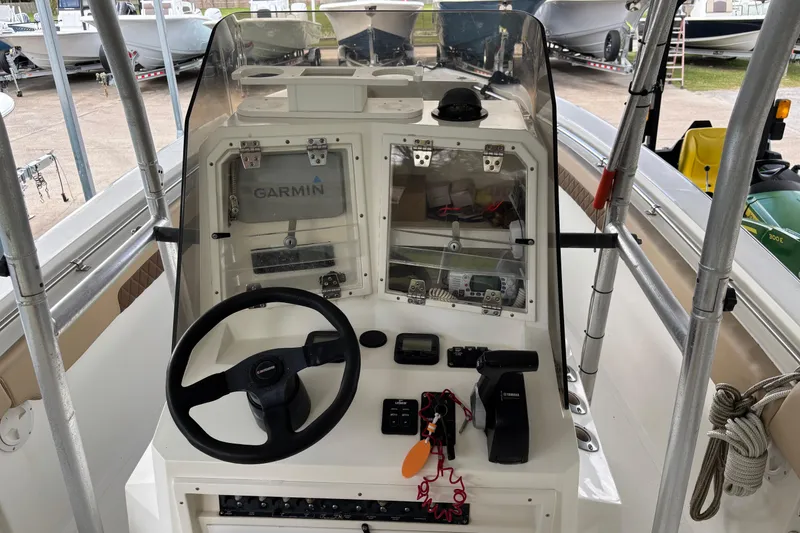 Slide: The Image of 1999 Contender 21 Open boat dashboard with Garmin navigation system and steering wheel. - 21