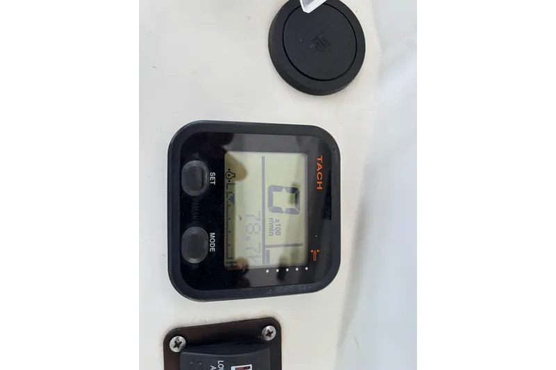 Slide: The Image of Tachometer display on a 1999 Contender 21 Open boat dashboard. - 23