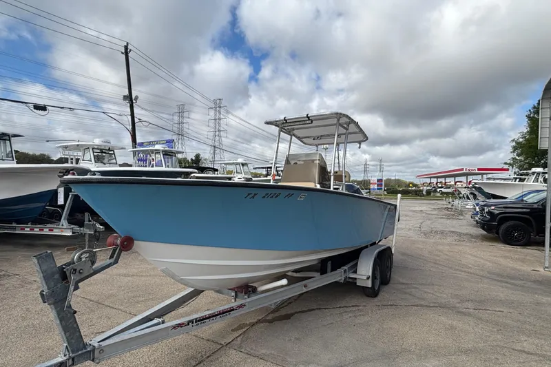 Slide: The Image of 1999 Contender 21 Open boat on trailer, parked outdoors under cloudy sky. - 4