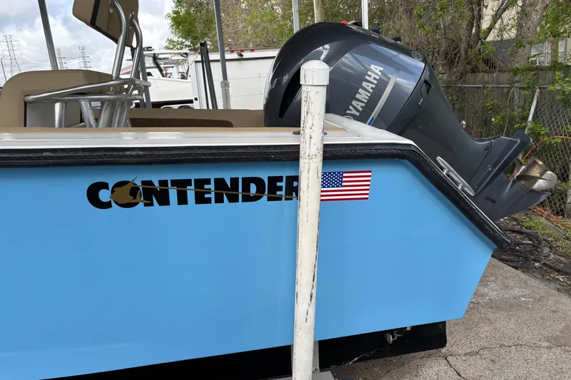 Slide: The Image of 1999 Contender 21 Open boat with Yamaha engine and American flag decal. - 7