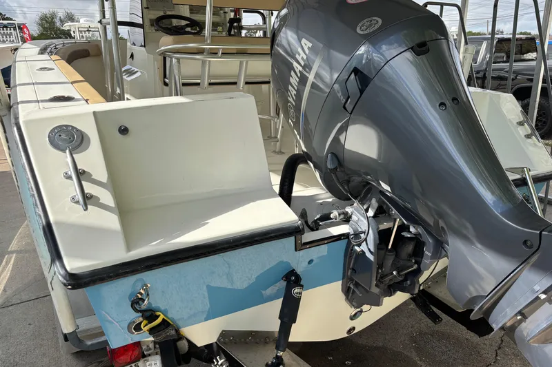 Slide: The Image of 1999 Contender 21 Open boat with Yamaha outboard motor, docked and ready for use. - 9