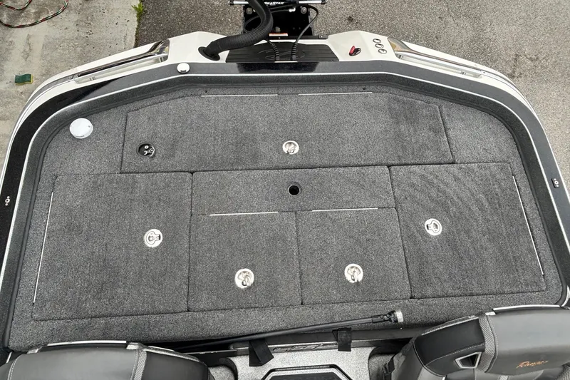 Slide: The Image of 2023 Ranger Z520R boat deck with storage compartments and carpeted surface. - 11