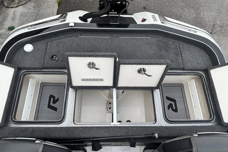 Slide: The Image of 2023 Ranger Z520R boat storage compartments with open lids, showcasing interior space. - 12