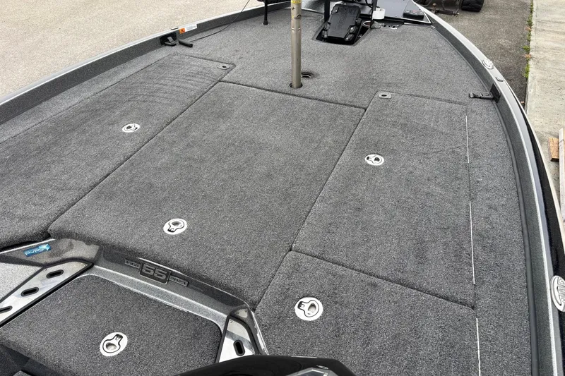 Slide: The Image of 2023 Ranger Z520R boat deck with gray carpet and storage compartments. - 5