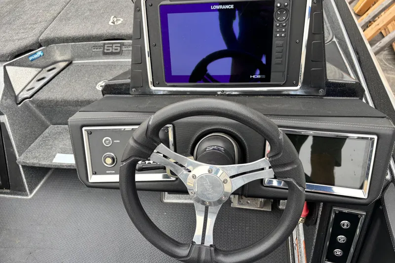 Slide: The Image of 2023 Ranger Z520R boat dashboard with steering wheel and Lowrance HDS display. - 9