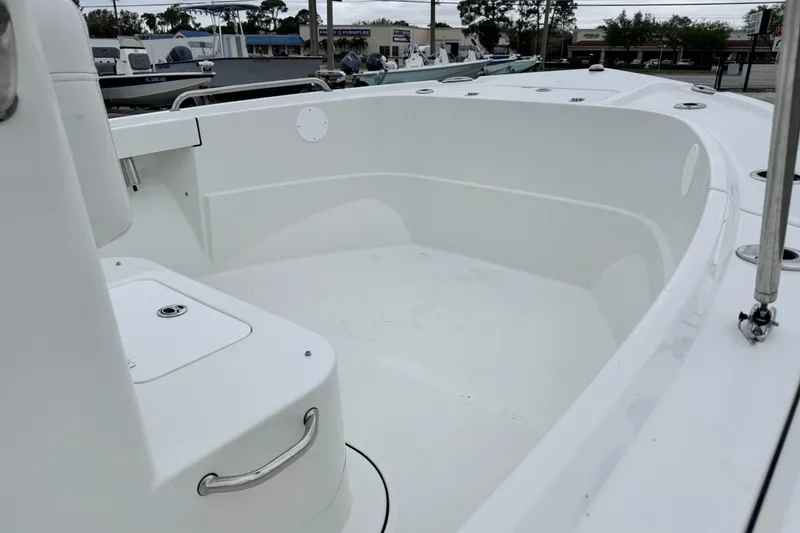 Slide: The Image of 2026 Parker 180 Coastal boat interior, showcasing spacious white deck and seating area. - 13