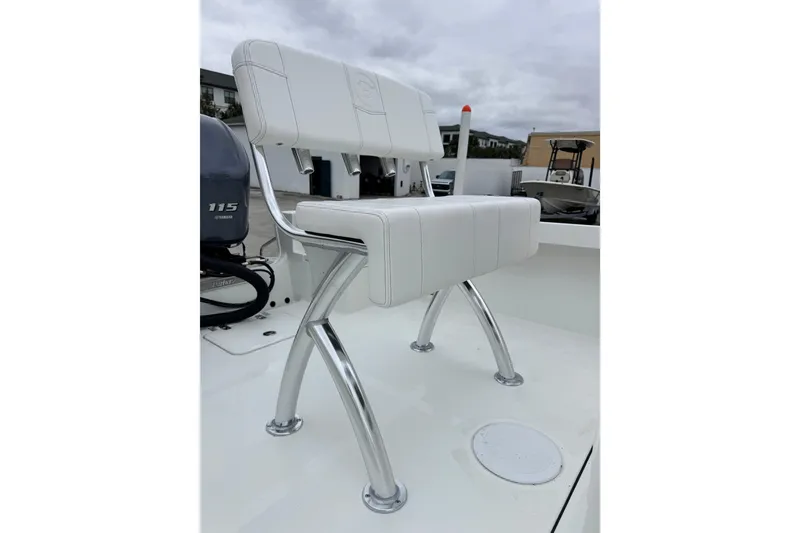 Slide: The Image of White cushioned seat on 2026 Parker 180 Coastal boat with chrome supports. - 16