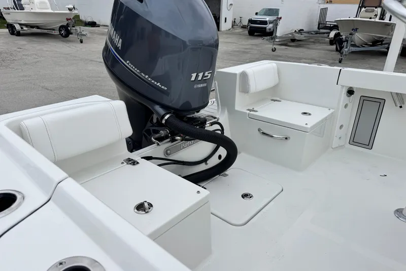 Slide: The Image of 2026 Parker 180 Coastal boat with Yamaha 115 engine, featuring white seating and storage compartments. - 17