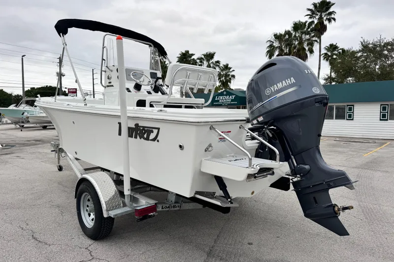 Slide: The Image of 2026 Parker 180 Coastal boat with Yamaha engine on trailer in parking lot. - 8