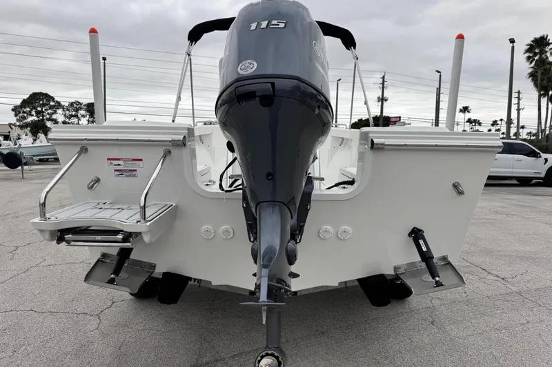 Slide: The Image of 2026 Parker 180 Coastal boat with 115 HP outboard motor, rear view in parking lot. - 9