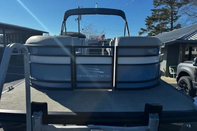 Slide: The Image of 2021 Bennington 23 LXS Swingback pontoon boat, rear view, parked outdoors. - 11