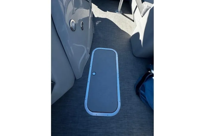 Slide: The Image of Interior view of 2021 Bennington 23 LXS Swingback boat, featuring a floor hatch. - 9