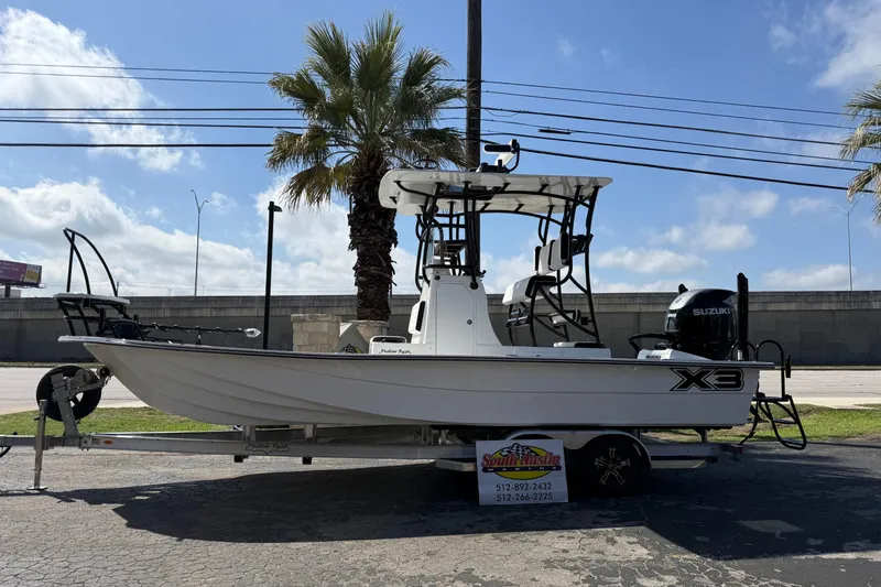 The Image of 2026 Shallow Sport 25 X3 boat on trailer, parked outdoors under clear sky. - 0