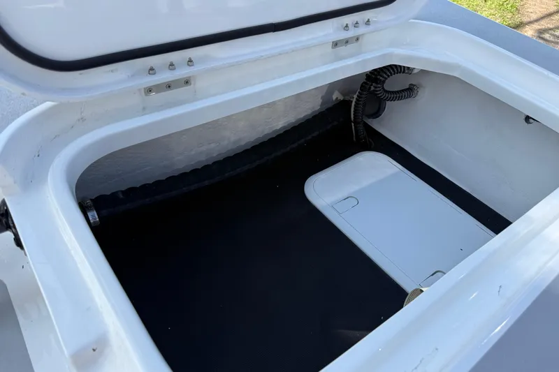 Slide: The Image of Open storage compartment in 2026 Shallow Sport 25 X3 boat. - 11