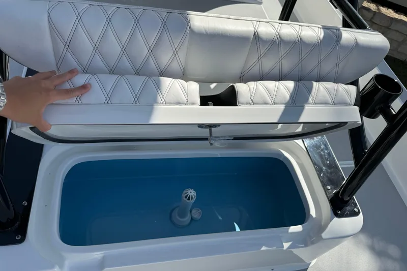 Slide: The Image of 2026 Shallow Sport 25 X3 boat seat with storage compartment open. - 15