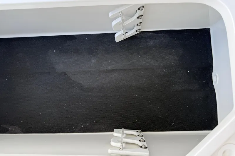 Slide: The Image of Interior view of 2026 Shallow Sport 25 X3 boat compartment with black lining. - 22