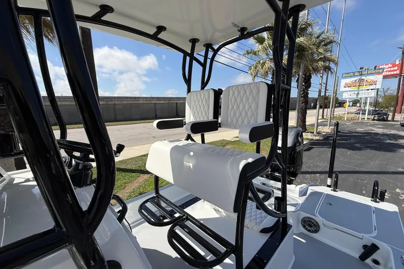 Slide: The Image of 2026 Shallow Sport 25 X3 boat interior with cushioned seating and sturdy framework. - 25