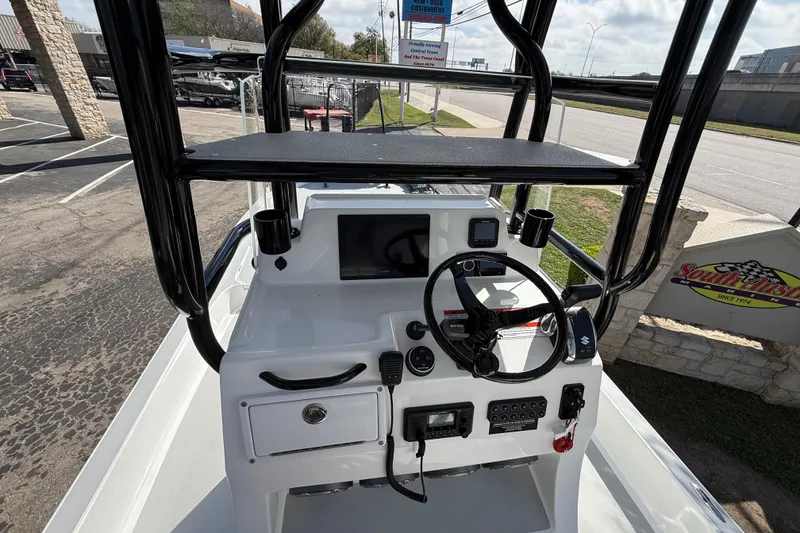 Slide: The Image of 2026 Shallow Sport 25 X3 boat console with steering wheel and navigation equipment. - 26
